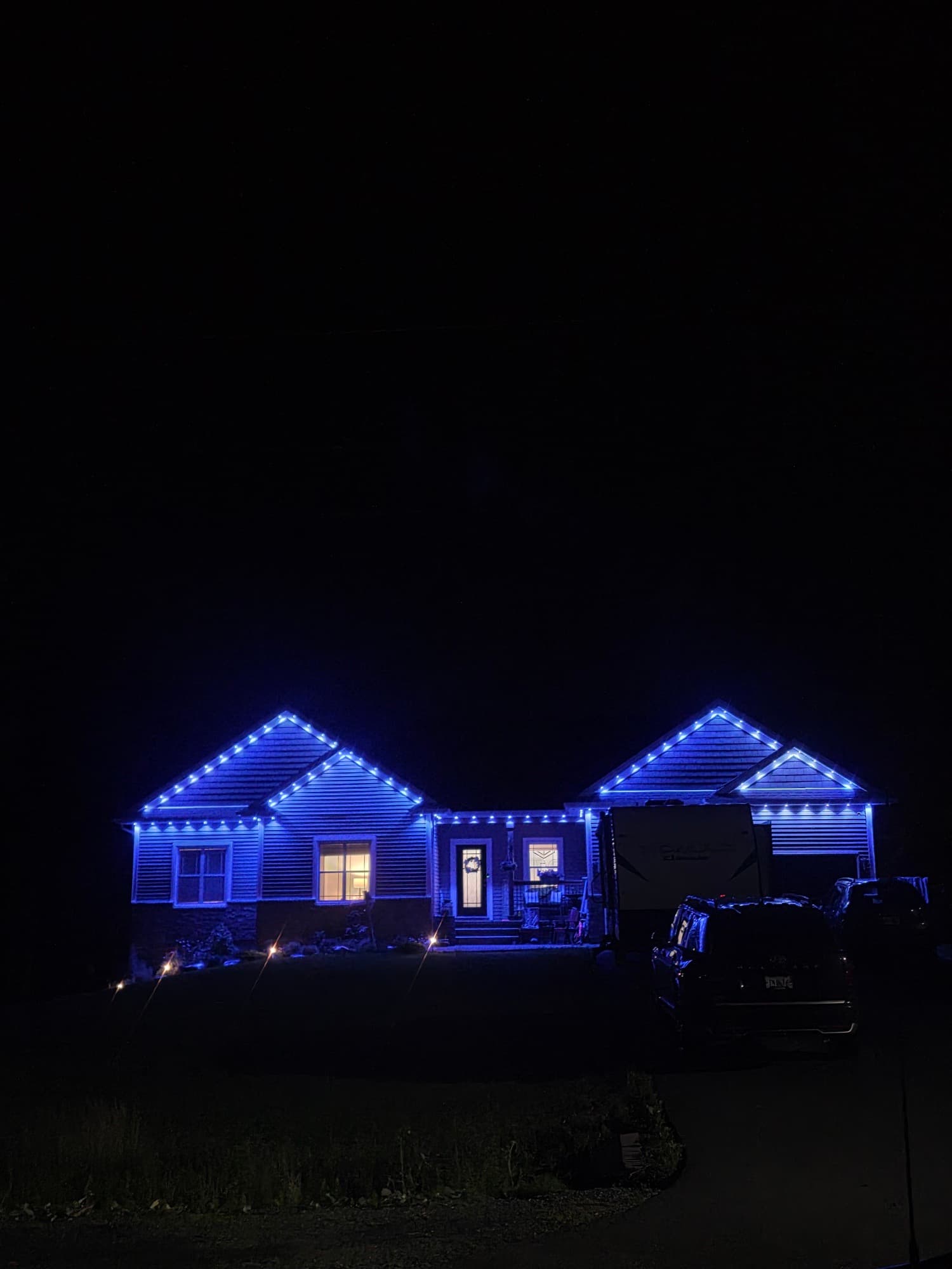 Bungalow outlined in blue GOVEE permanent lights at night