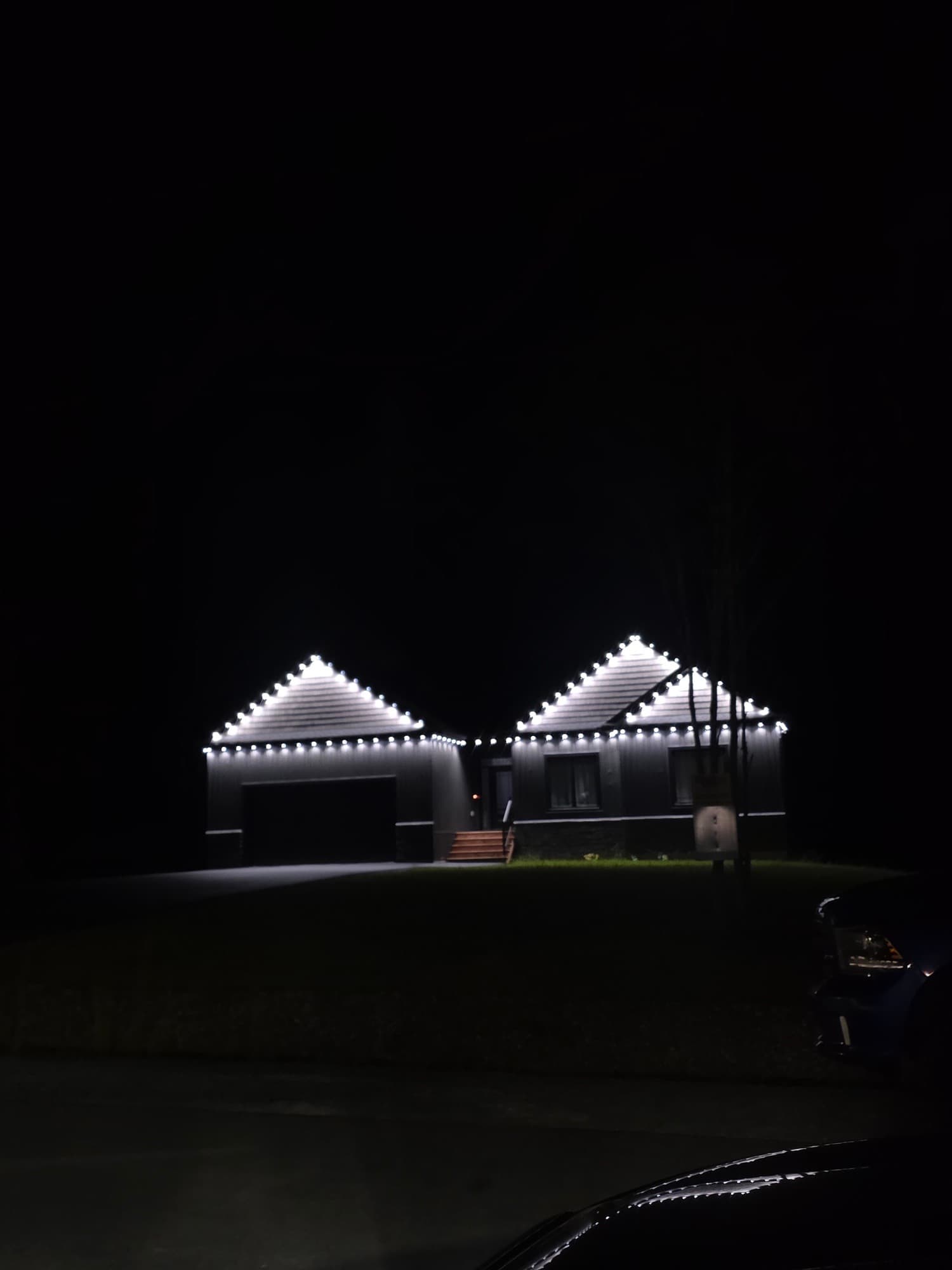 Home and garage outlined in warm white lights