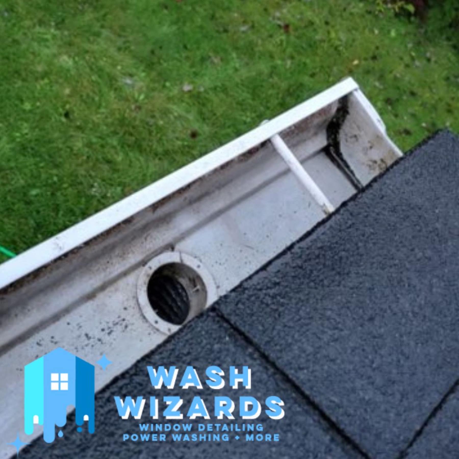 A cleared gutter and downspout outlet at the edge of a roof
