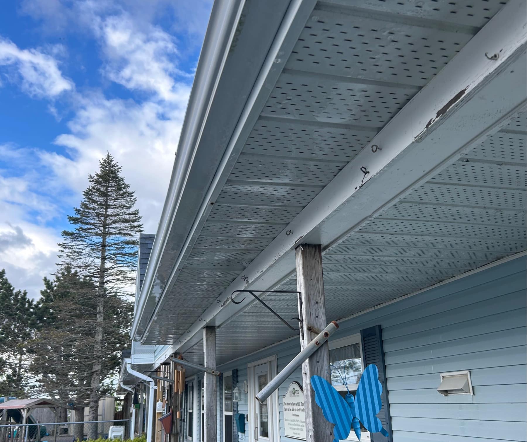 A row of soffits and siding along a building, freshly washed