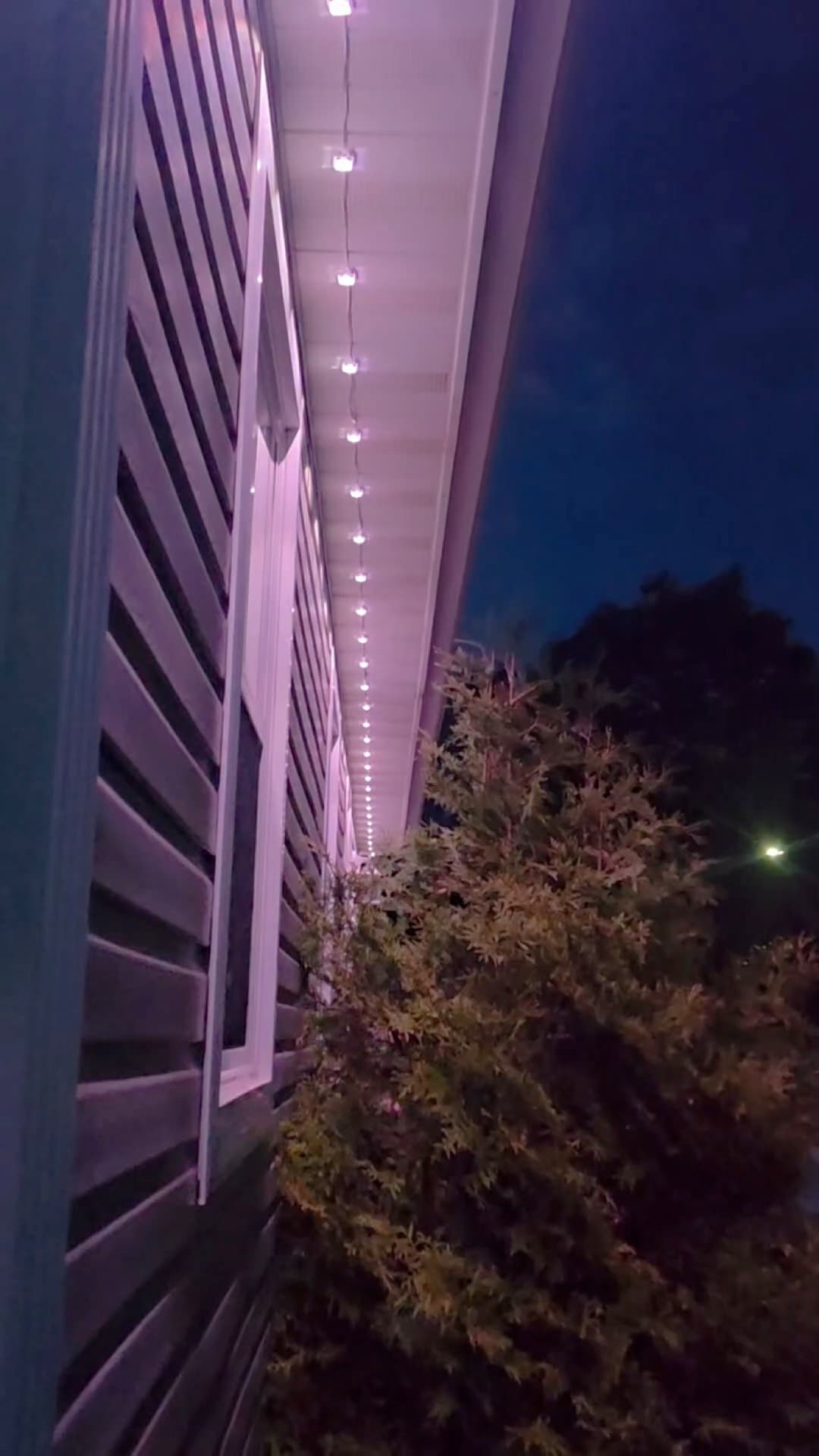 GOVEE lights glowing along the soffit of a house at night